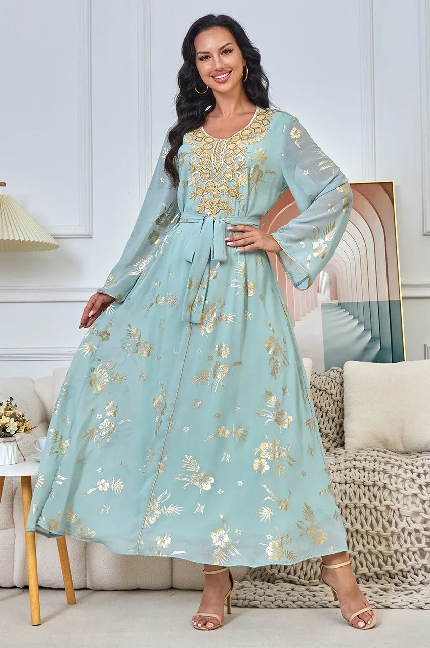 Elegant woman wearing the Malika Aqua Gold moroccan kaftan evening dress, perfect for wedding guests.