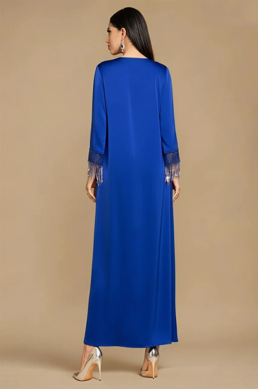 Back view of blue fringed kaftan with long sleeves and fluid drape