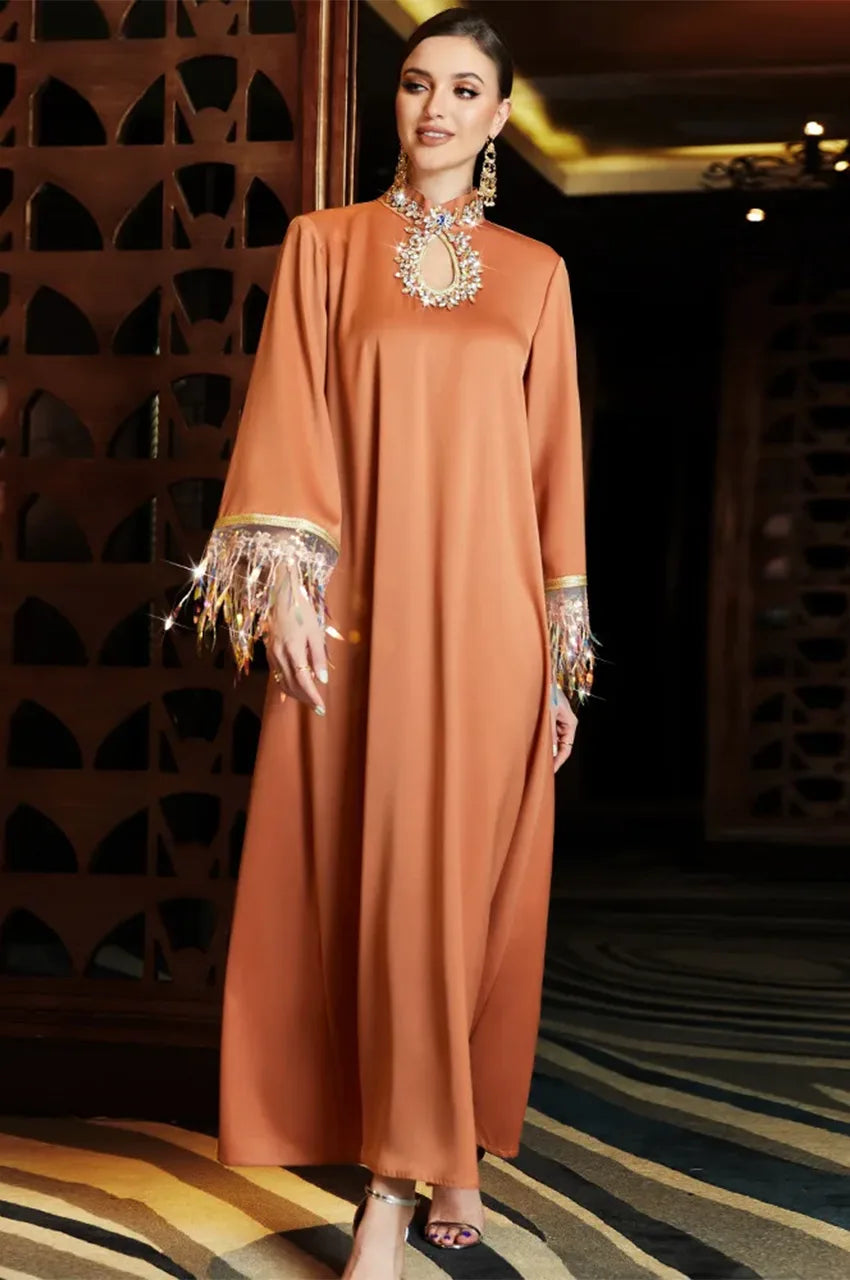 Model walking in Luzia orange satin fringed kaftan