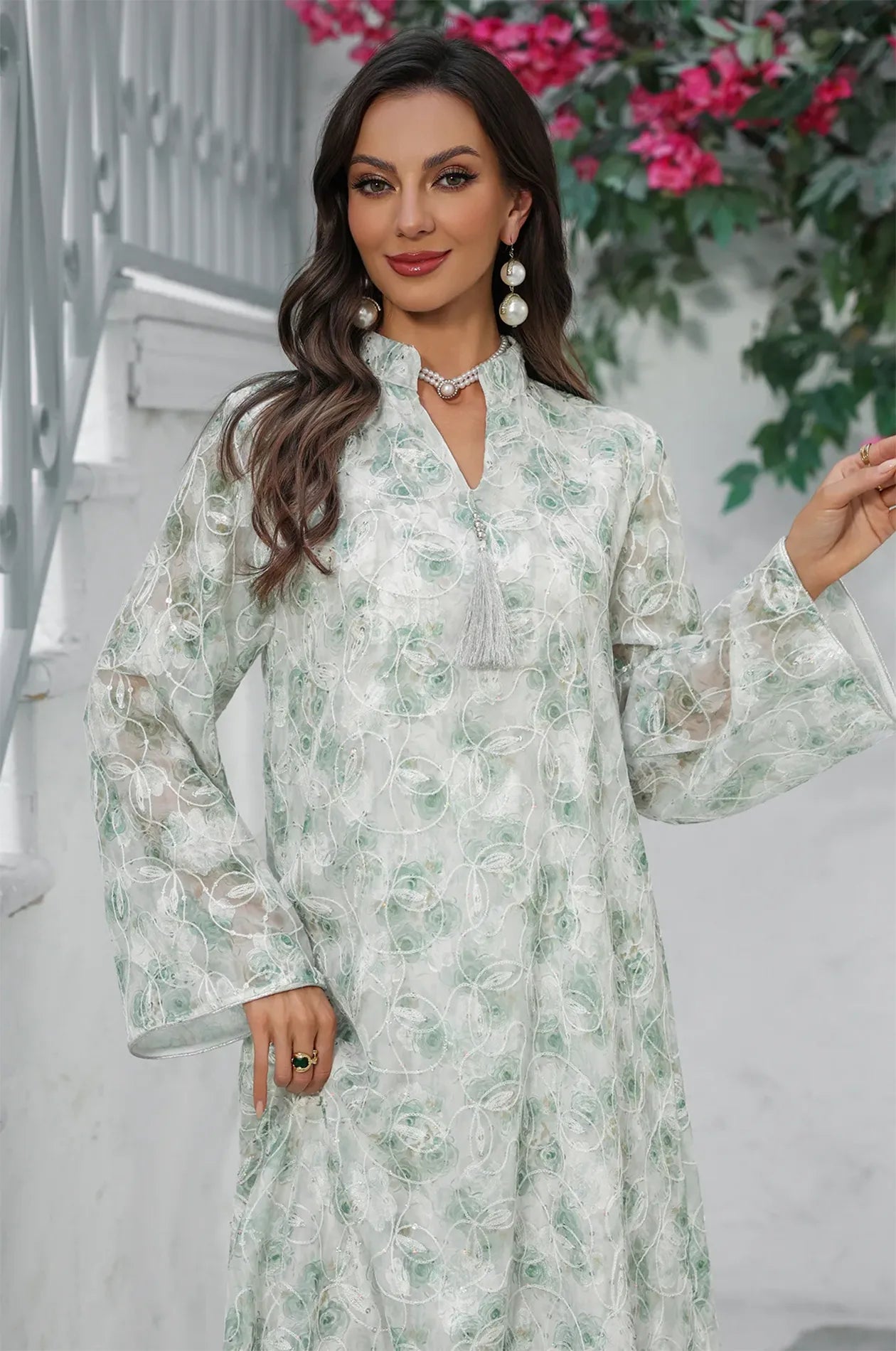 Detailed shot of the Lyana kaftan's mandarin collar and decorative tassel.