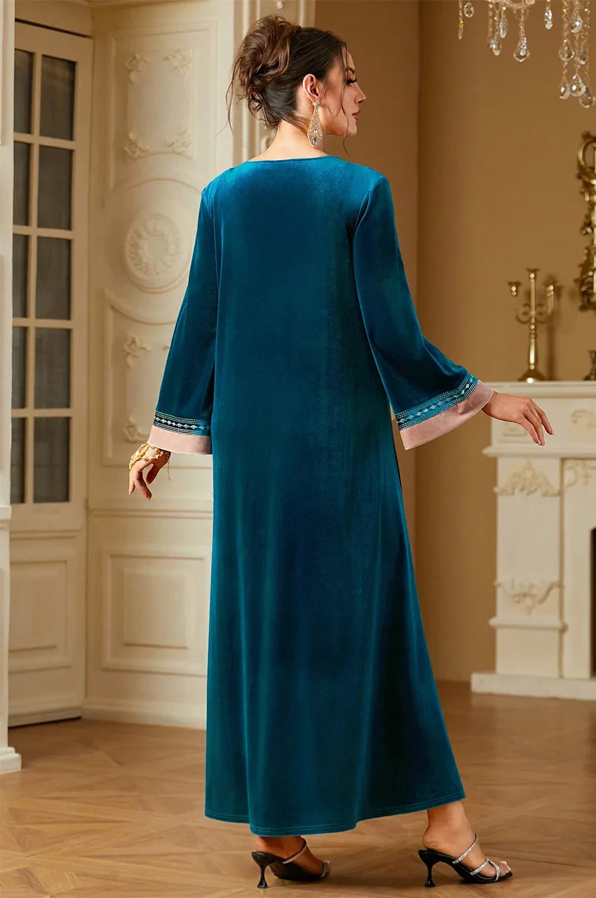 Rear angle view of Lylah kaftan highlighting the teal color and hemline.