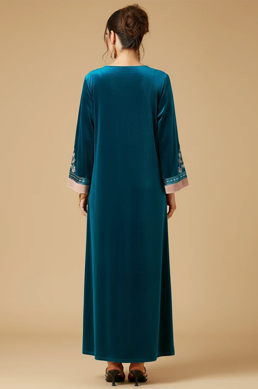 Back view of Lylah blue velvet kaftan showing smooth drape and contrast cuffs.