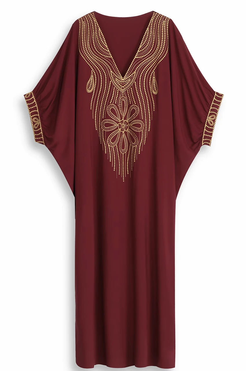 Flat lay of Maela chocolate kaftan showing gold floral embroidery