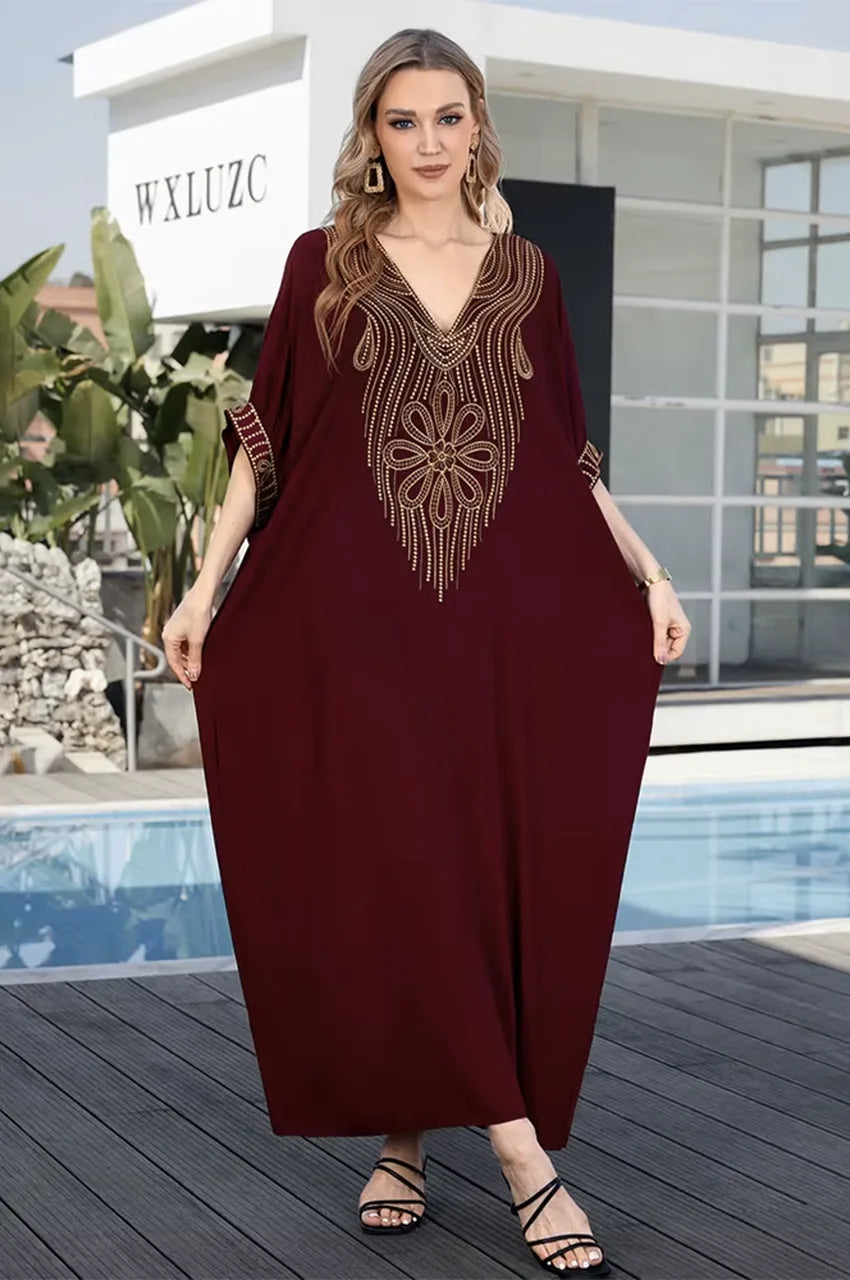 Full body outdoor view of Maela chocolate kaftan near pool