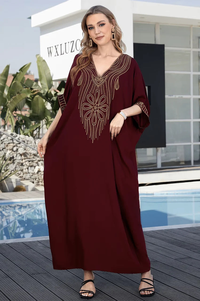 Gold embroidered neckline on Maela chocolate kaftan near pool