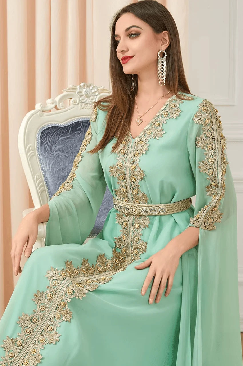 Close-up of gold floral embroidery on Maelis green Moroccan traditional kaftan