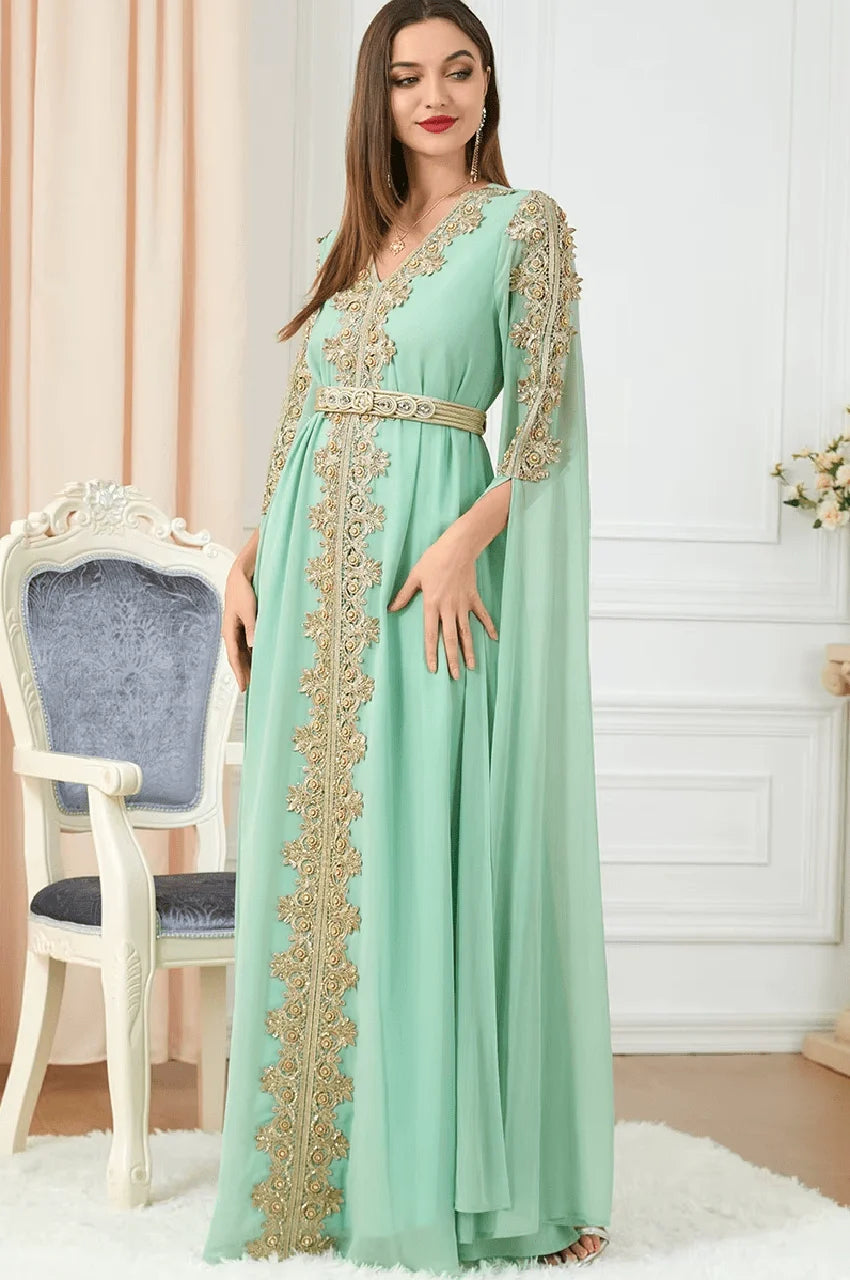 Side pose of Maelis green Moroccan traditional kaftan with flowing cape sleeves