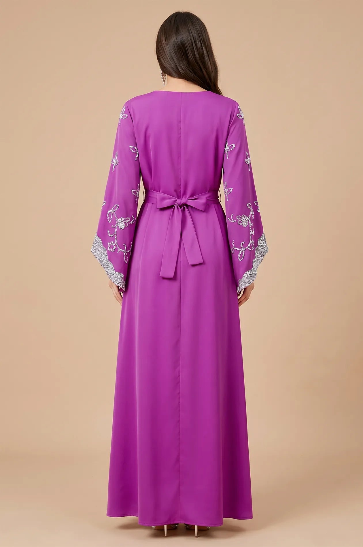 Rear view of the Magenta Maya Kaftan highlighting the adjustable bow-tie belt and floor-length silhouette.