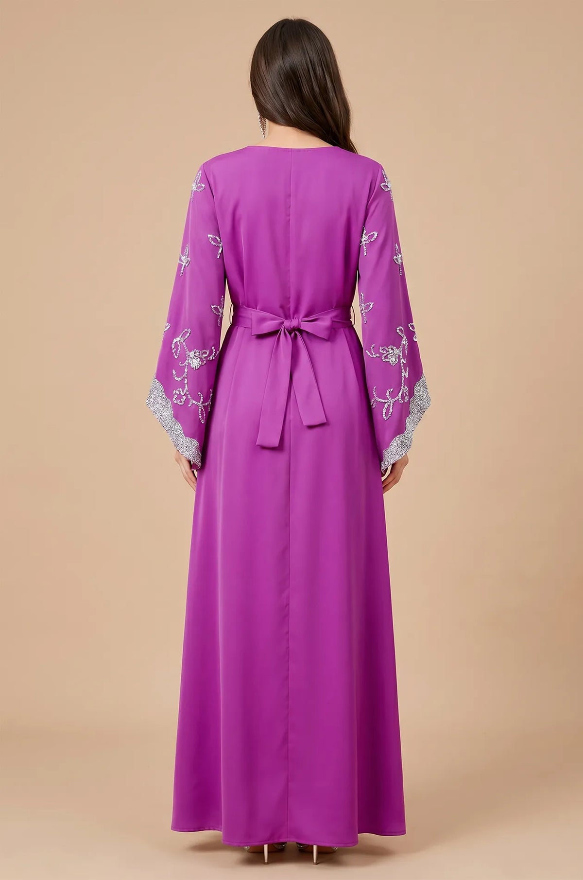 Rear view of the Magenta Maya Kaftan highlighting the adjustable bow-tie belt and floor-length silhouette.