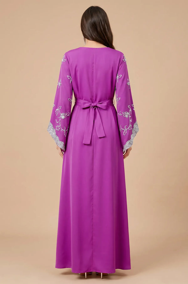 Rear view of the Magenta Maya Kaftan highlighting the adjustable bow-tie belt and floor-length silhouette.