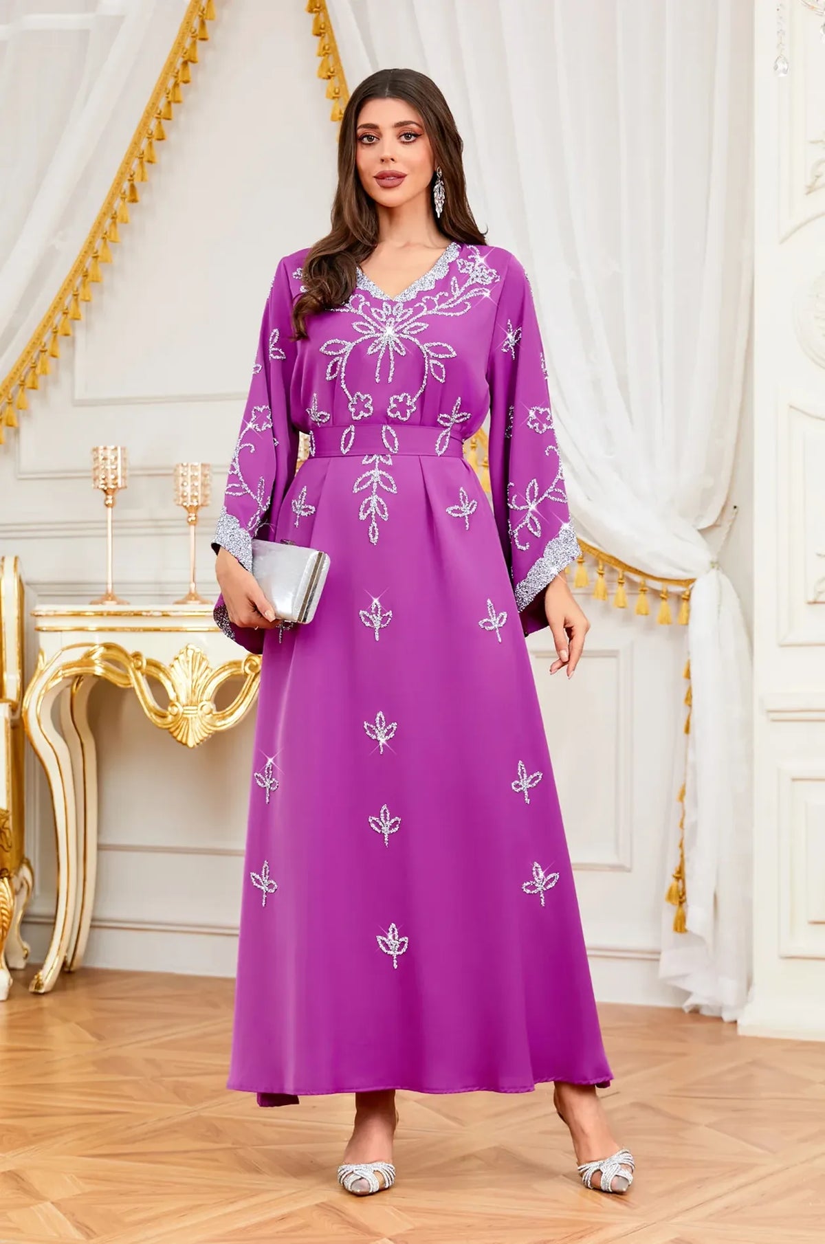 Elegant Magenta Maya Kaftan featuring silver floral embroidery styled with a matching silver clutch.