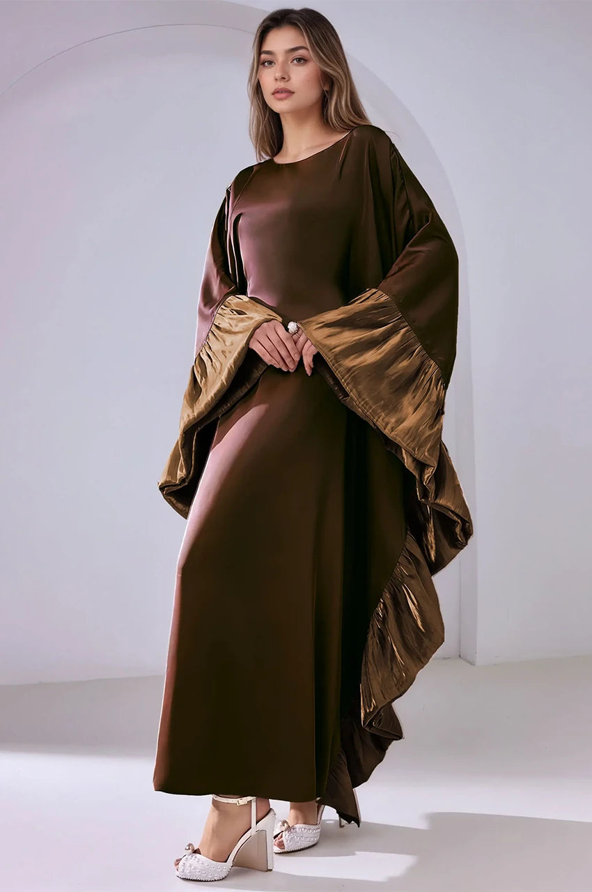 Artistic angled pose wearing the Malya brown ruffle kaftan with layered sleeves