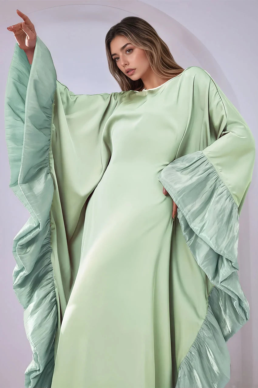 Malya green ruffle kaftan with dramatic cascading sleeve detail in close-up pose