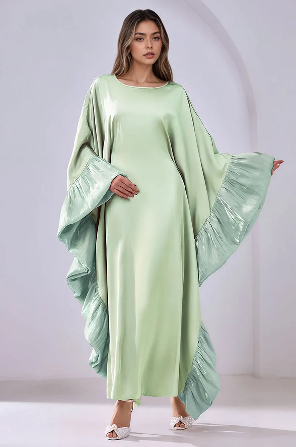 Green Malya ruffle kaftan with flowing sleeves and airy ruffle movement in full-body pose