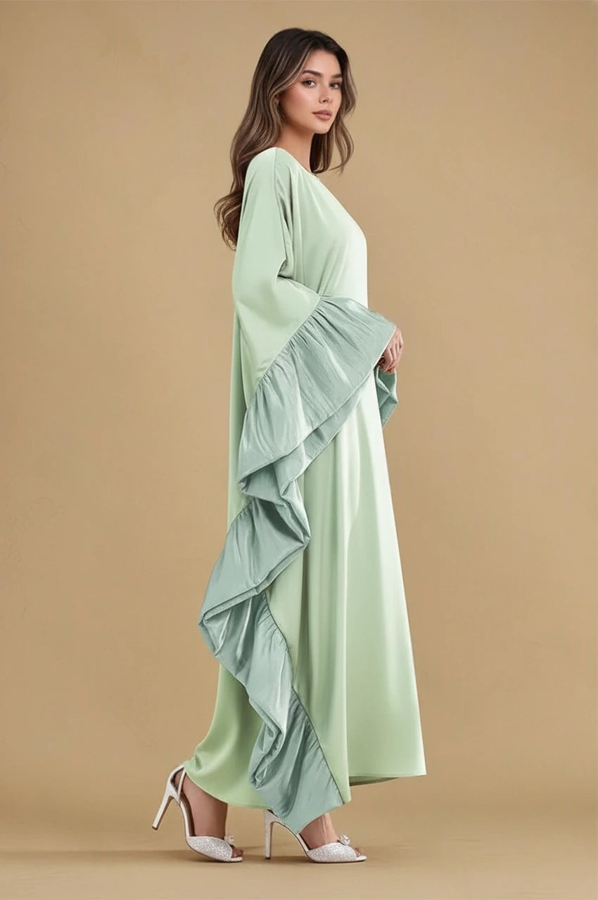 Side view of Malya green ruffle kaftan showing cascading side ruffles and elegant flow