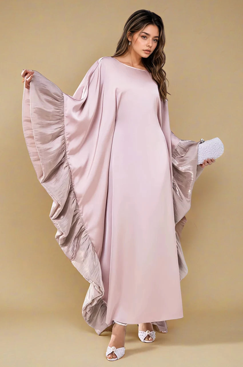 Full-length side view of Malya ruffle kaftan in pink showing cascading ruffles