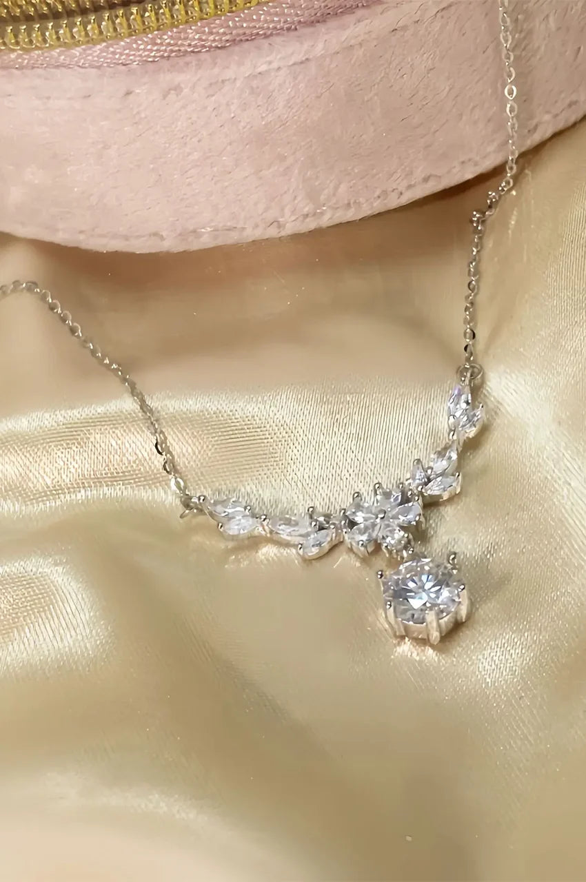 Detailed view of marquise cut stones on silver floral necklace