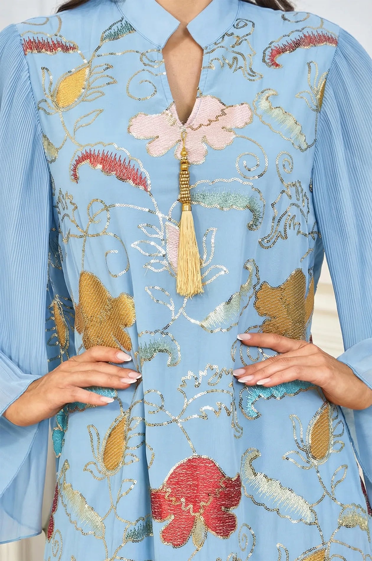 Close-up detail of the Marylin Light Blue Kaftan bodice, featuring the V-neck collar, luxury gold tassel, and hand-finished sequins.