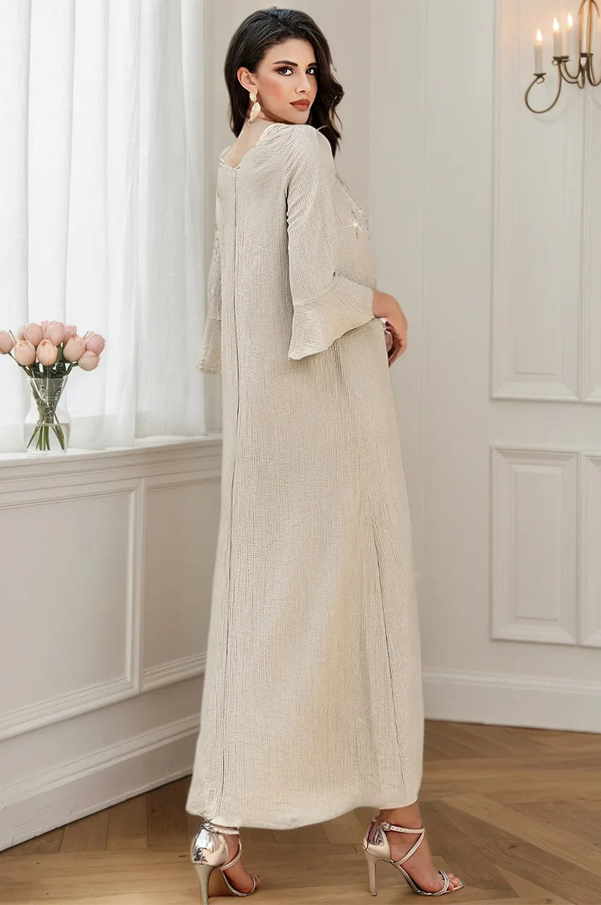 Angled back view showing the texture and hem of the Meira formal kaftan gown.