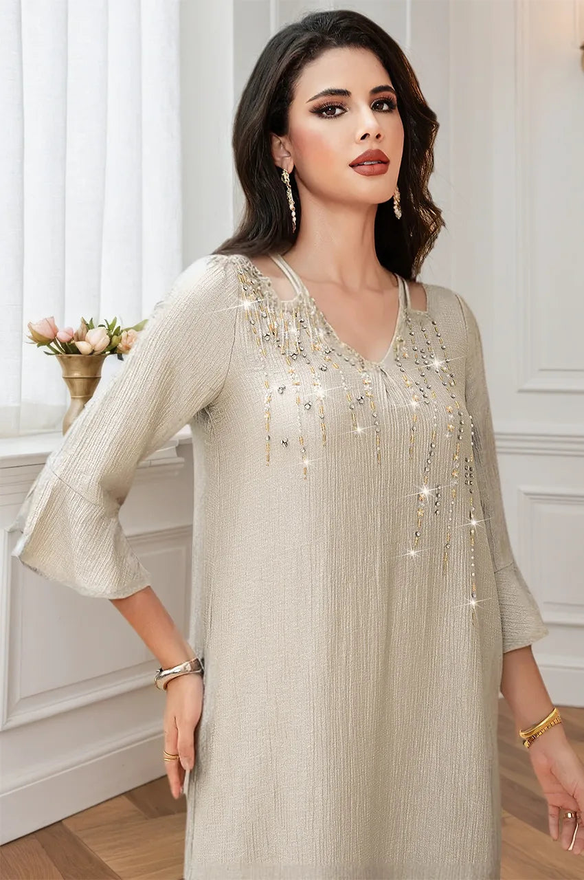 Close up of hand-placed crystal and bead detailing on Meira kaftan neckline.