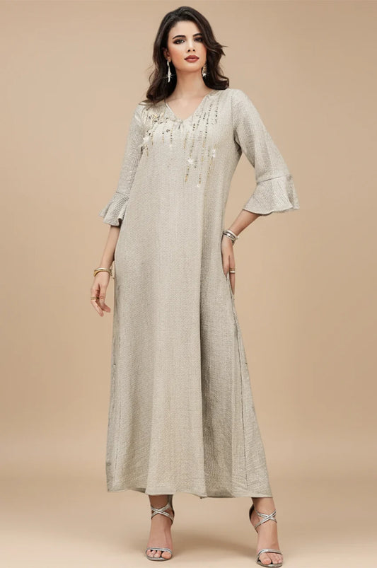 Model wearing Meira champagne formal kaftan gown with crystal embellishments front view.