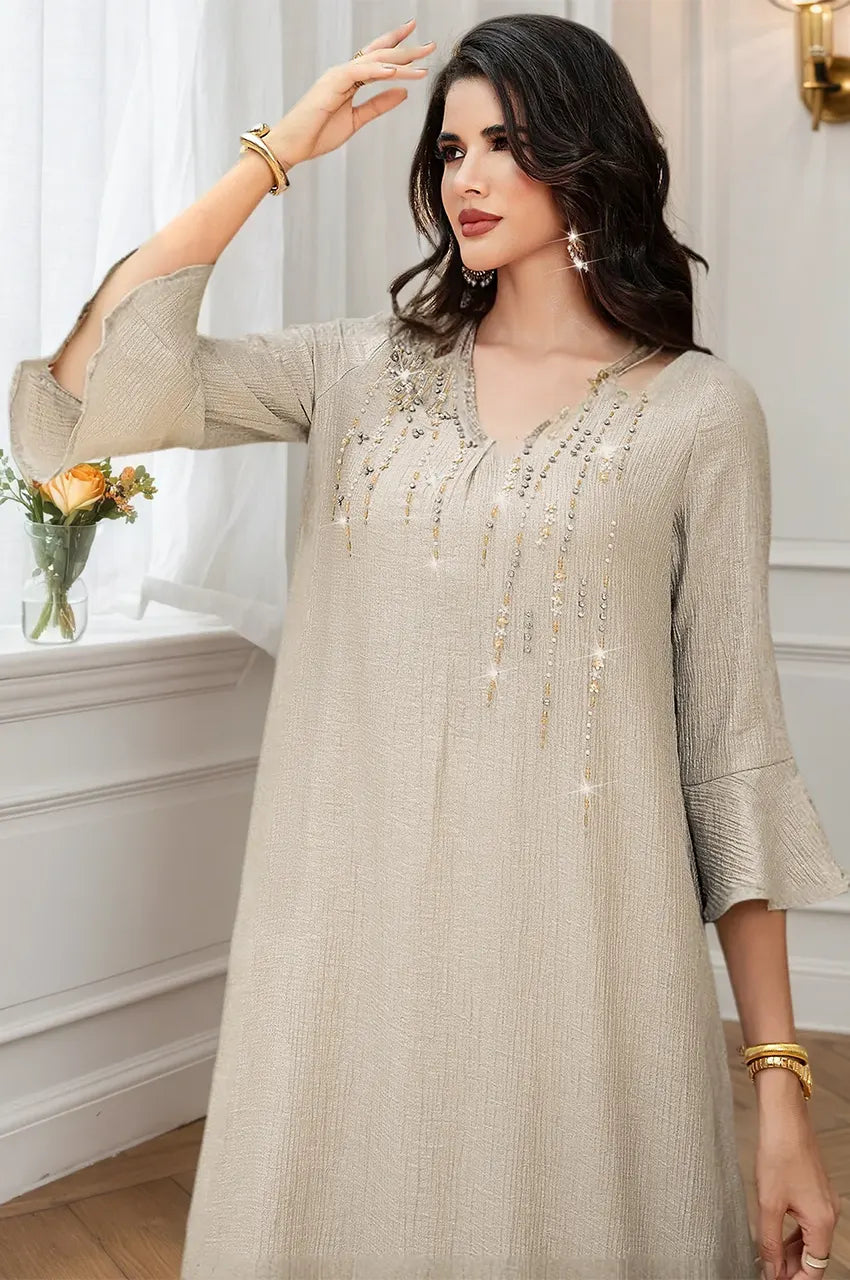 Detail shot of the flared bell sleeves on the Meira champagne kaftan.