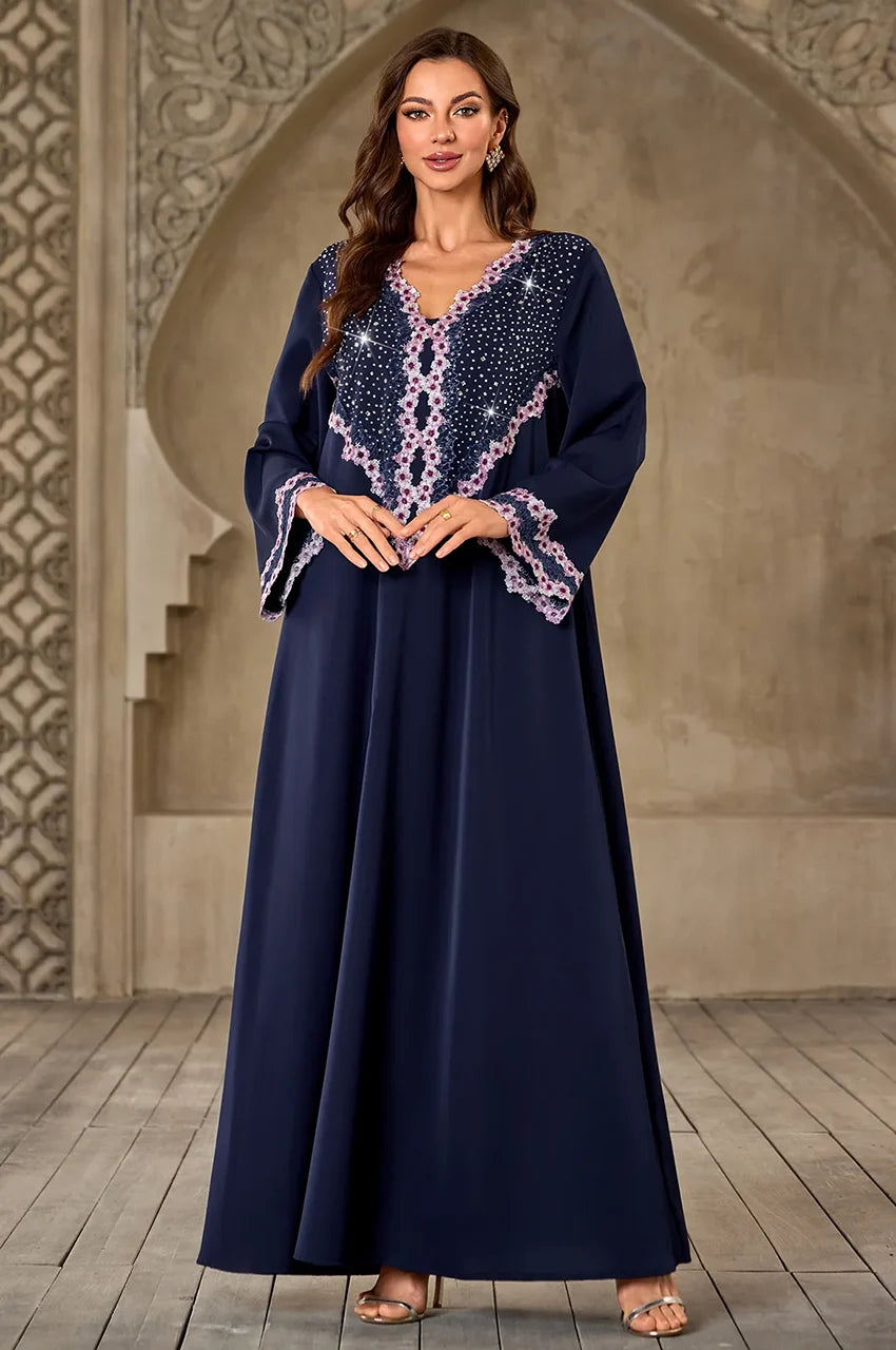 Front view of Milah dark blue kaftan with pink rhinestone chest detail.
