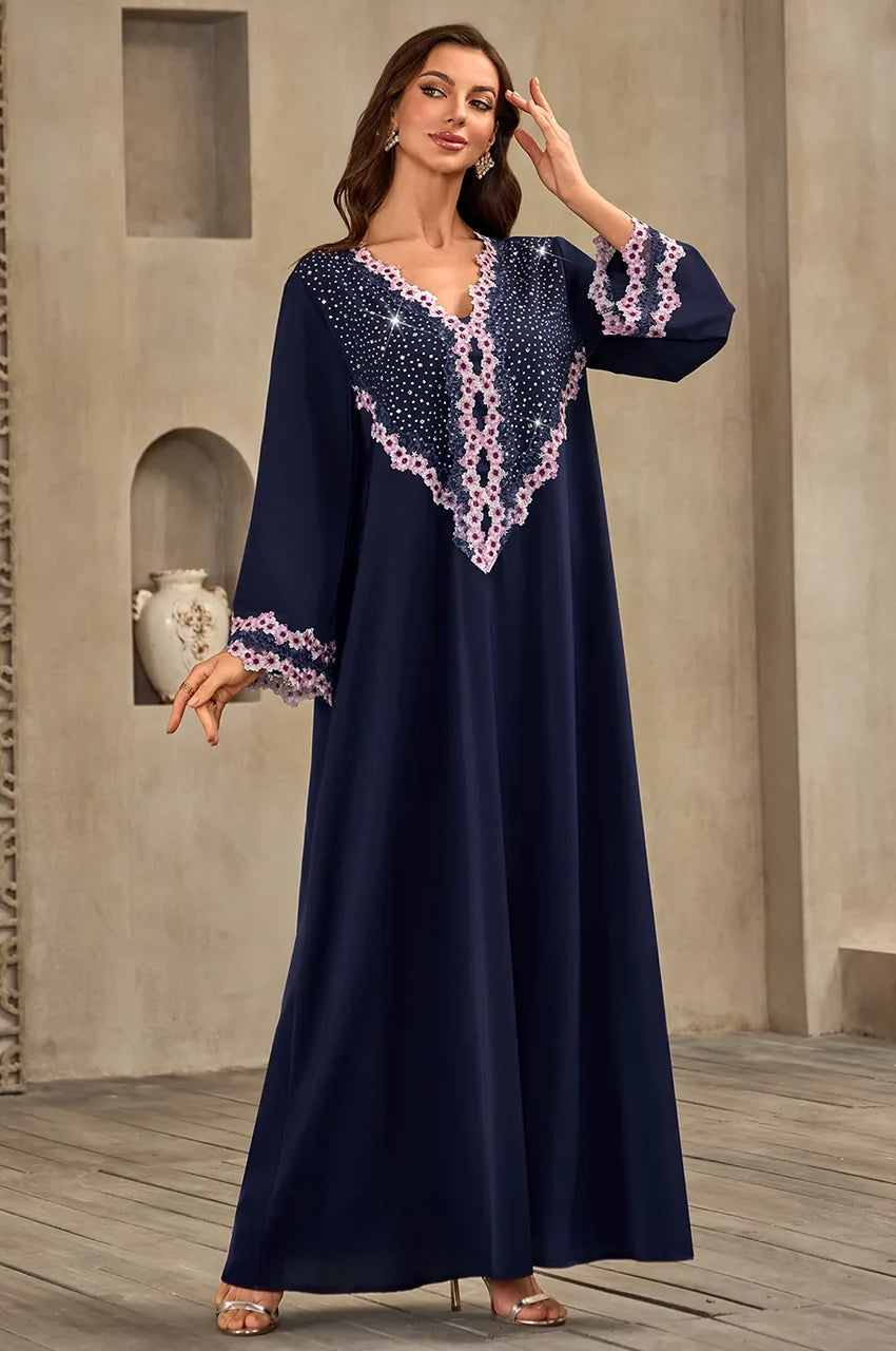 Elegant pose in the Milah dark blue rhinestone kaftan.