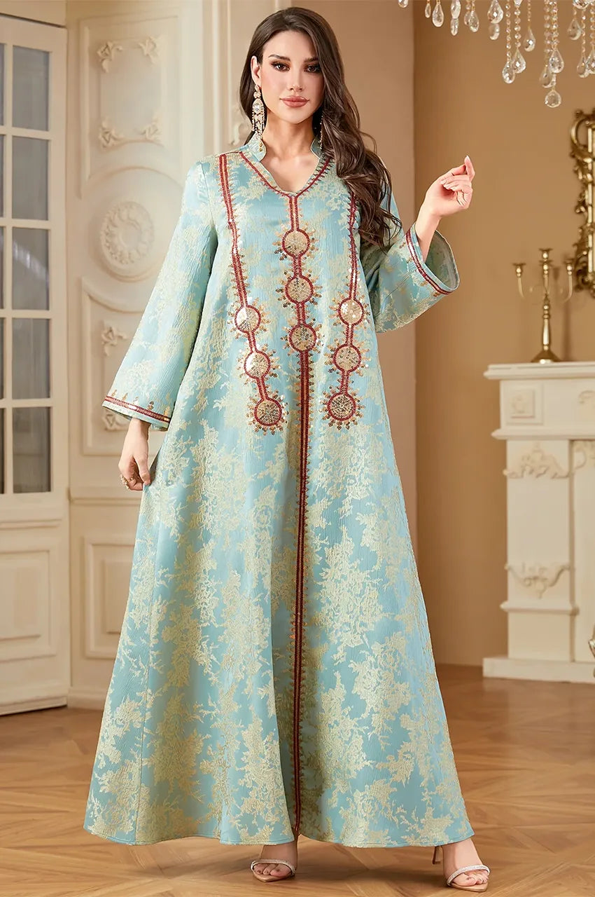Front view of Riyah mint green kaftan showing red and gold sequin details.