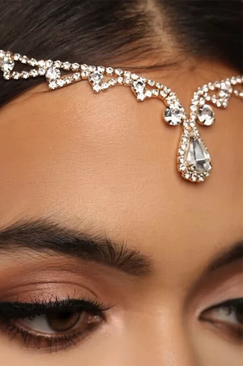 Close-up on a model's forehead wearing the luxury headpiece and teardrop crystal dangle side angle.