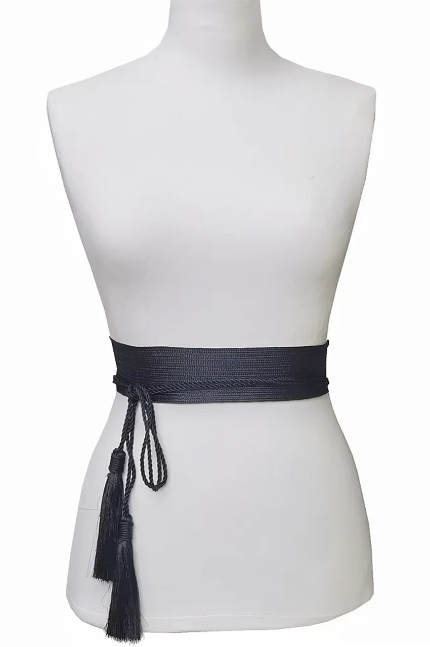 Mannequin wearing the black obi belt with tassel ties cinched over a white dress.