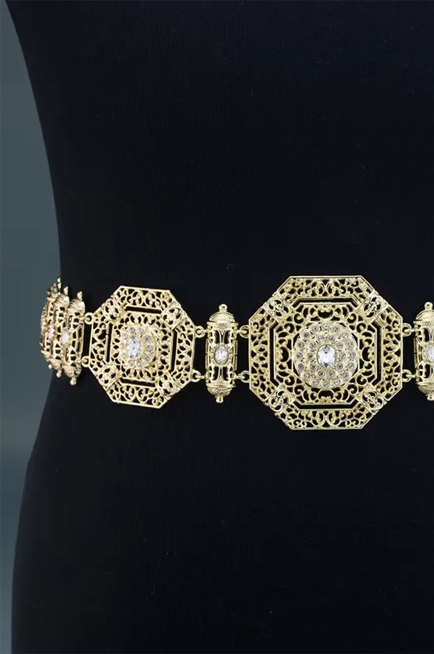 Front view of the gold octagonal filigree belt worn over a black dress to show contrast and fit.