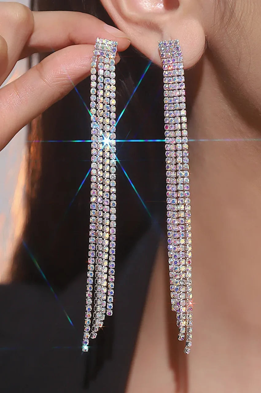 Model wearing long silver crystal fringe earrings to demonstrate shoulder-grazing length.