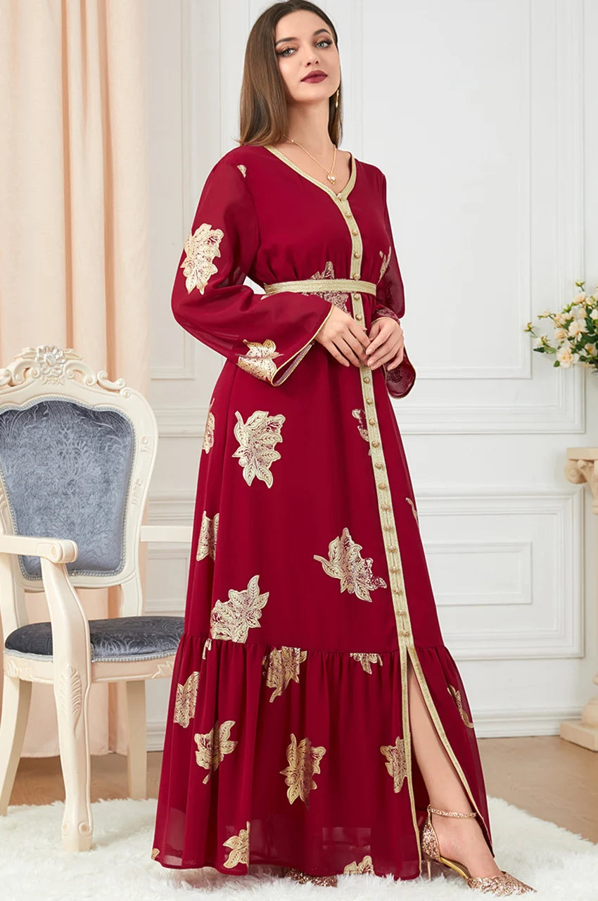 Side angle of red Myra vintage Moroccan kaftan with flowing sleeves and gold trim