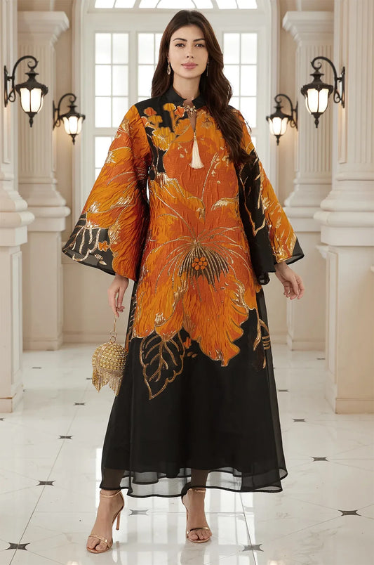 High-fashion frontal pose of the Naeli Orange Flowy Kaftan with bold black contrast and a sheer layered hemline.