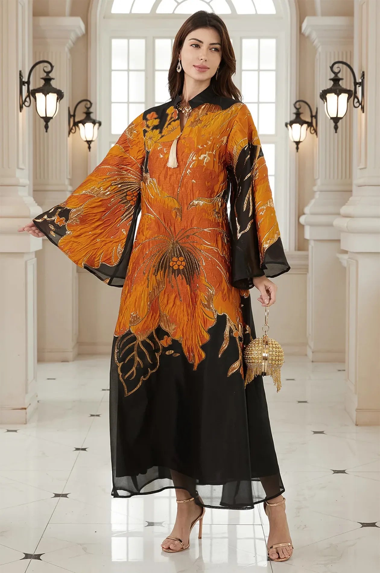Full-length view of the Naeli Orange Flowy Kaftan featuring metallic gold floral prints and butterfly sleeves.