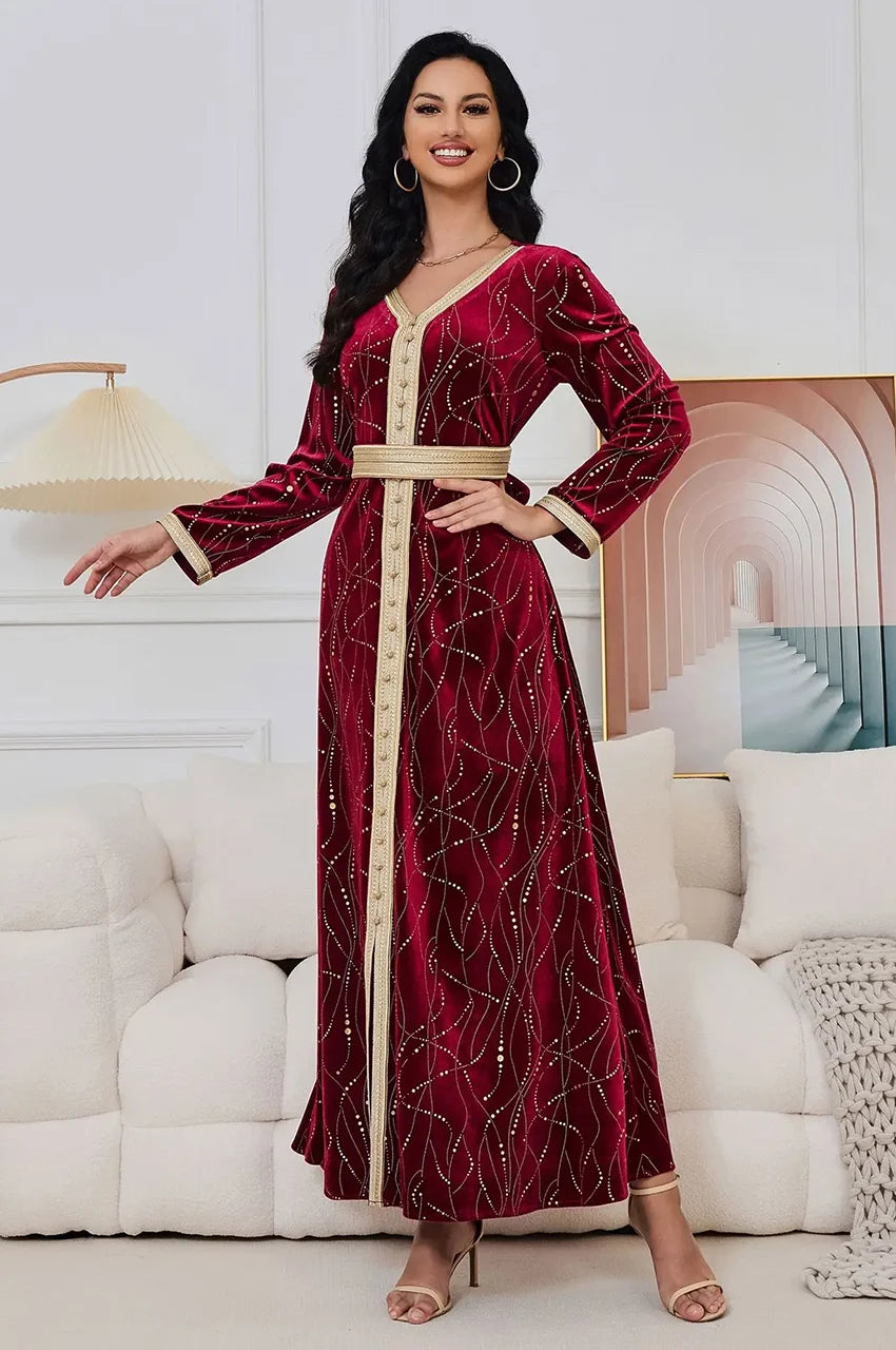 Elegant pose in Naeva velvet kaftan dress suitable for wedding guest attire.