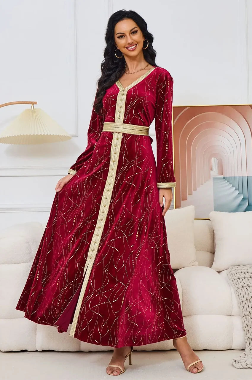 Model wearing Naeva red velvet kaftan showing fabric drape and A-line skirt.