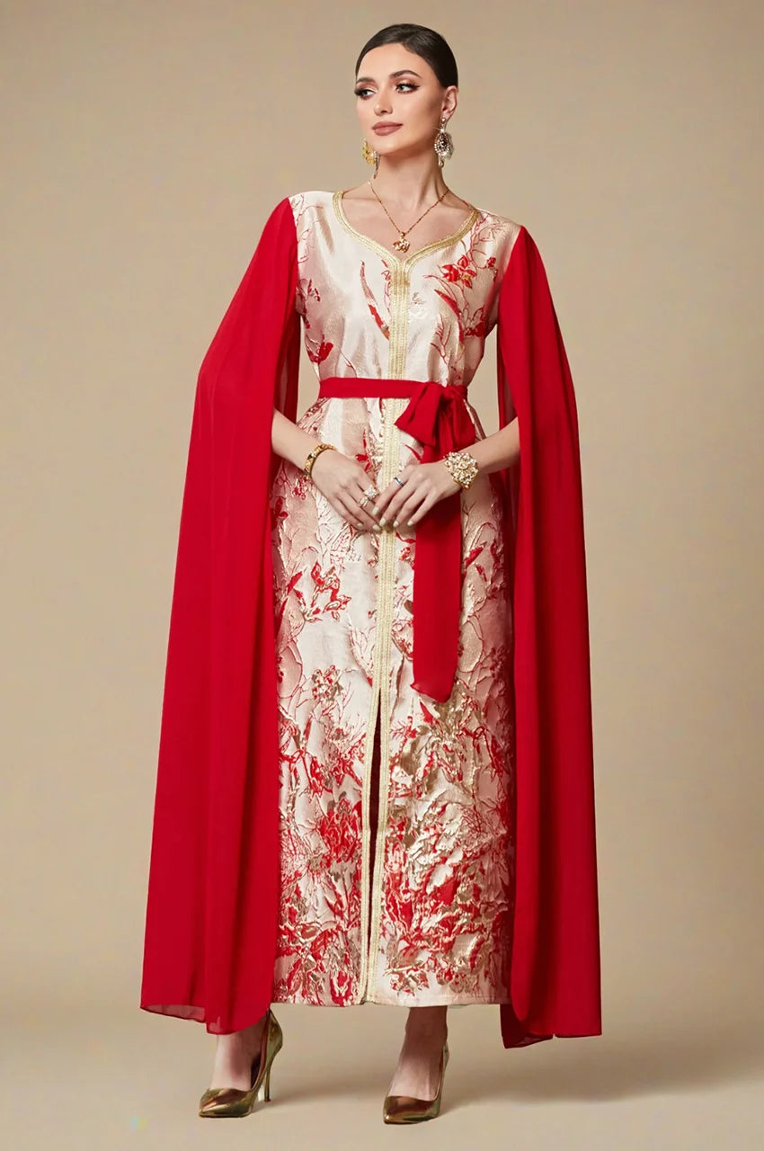 Model wearing red and white embroidered kaftan dress with cape sleeves