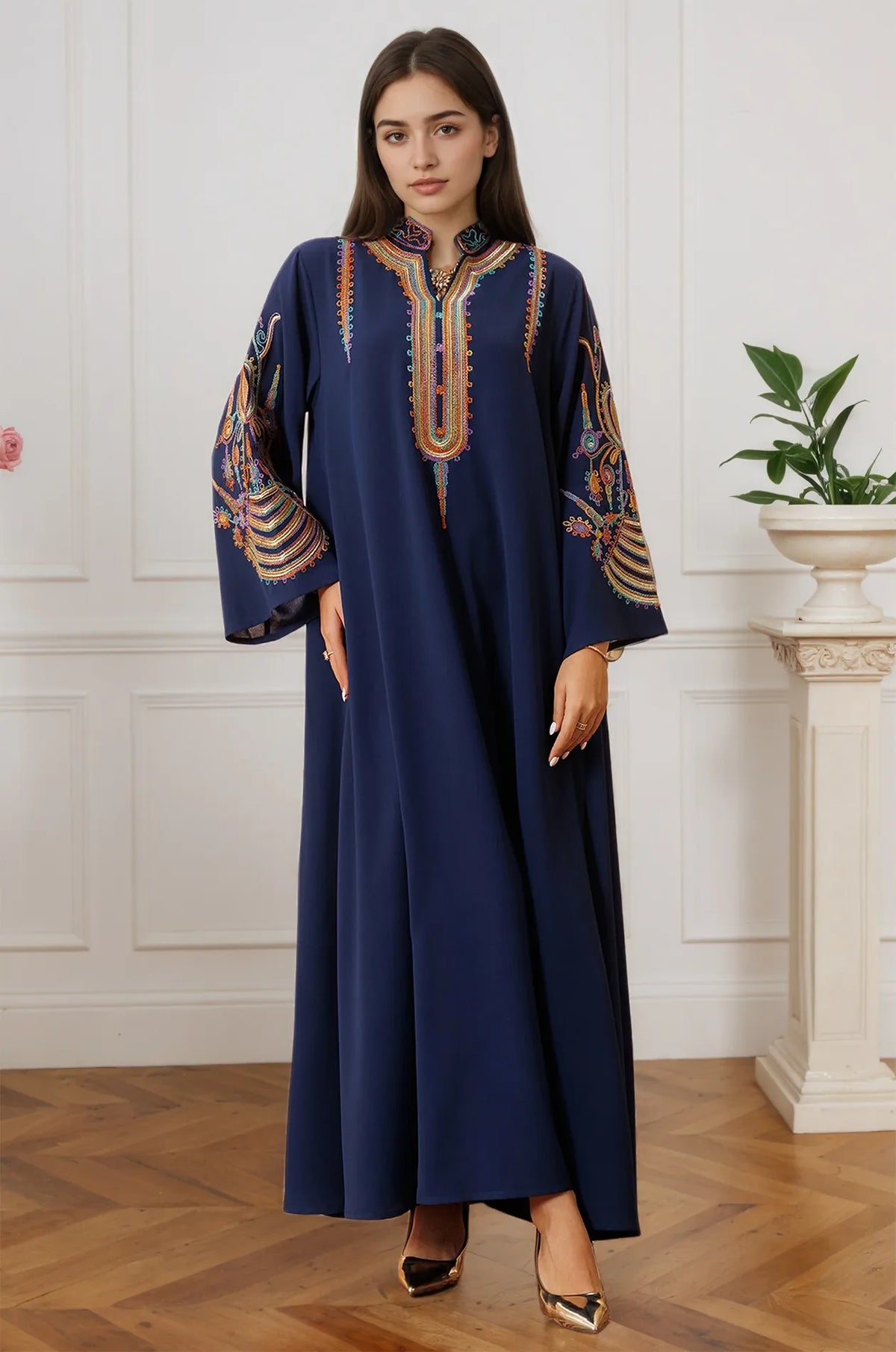 A model wearing the Inez Blue Jalabiya Kaftan in a luxury interior setting, highlighting the regal navy fabric.
