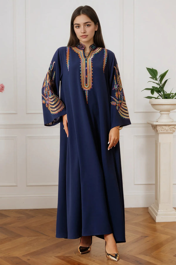 A model wearing the Inez Blue Jalabiya Kaftan in a luxury interior setting, highlighting the regal navy fabric.