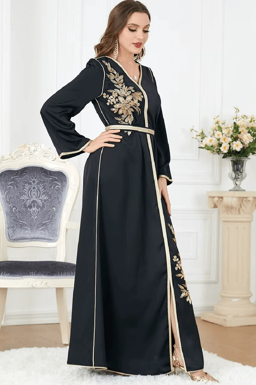 Side view showing embroidery and slit on black Naylah kaftan