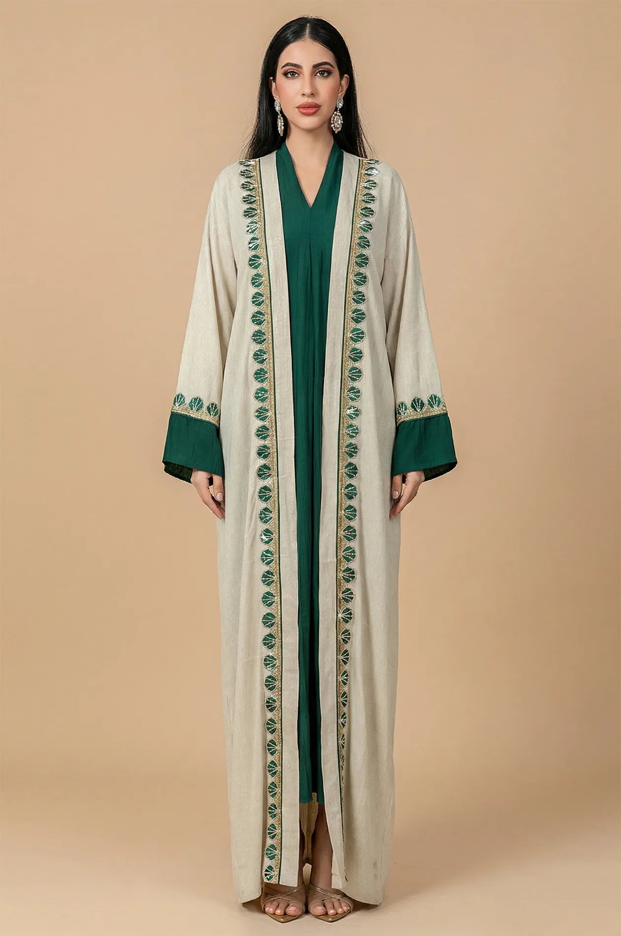Full-length front view of the Ameline beige kaftan dress featuring an emerald green inner gown and hand-beaded borders by Naylara.