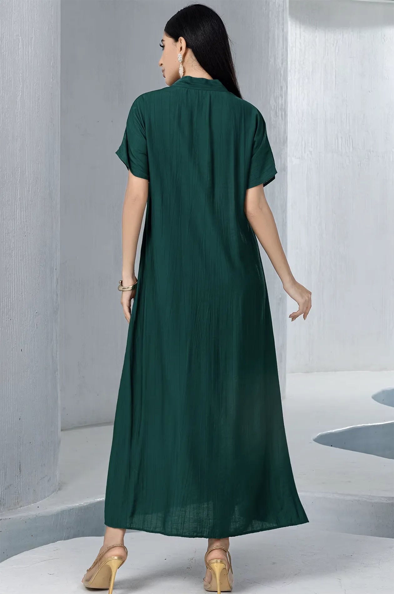 Back view of the ankle-length emerald green pleated inner dress, showcasing the high-quality fabric and soft texture of the Ameline set.