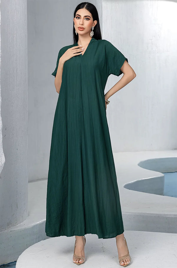 Front view of the separate emerald green pleated inner dress from the Ameline kaftan collection, featuring a classic V-neckline.