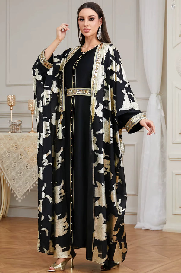 An elegant standing shot of the Black Puppis kaftan luxe by Naylara, a perfect choice for high-end formal evening wear.