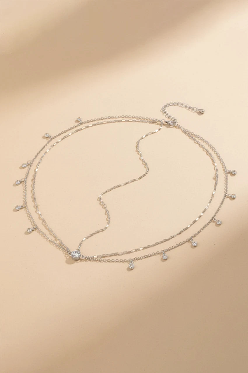 Flat lay of the dainty silver-tone layered head chain with rhinestones.