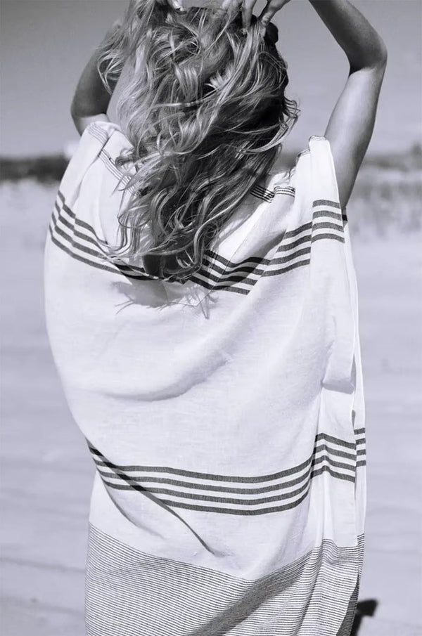Naylara Dalia striped maxi kaftan in motion on sandy beach — lightweight cotton summer dress