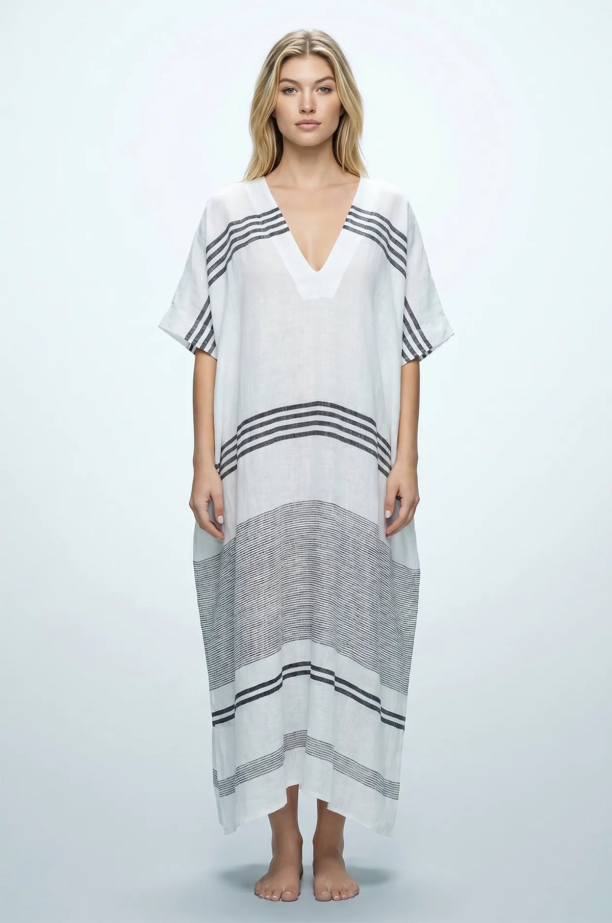 Naylara Dalia white and black striped maxi kaftan — front view with deep V-neck, studio shot