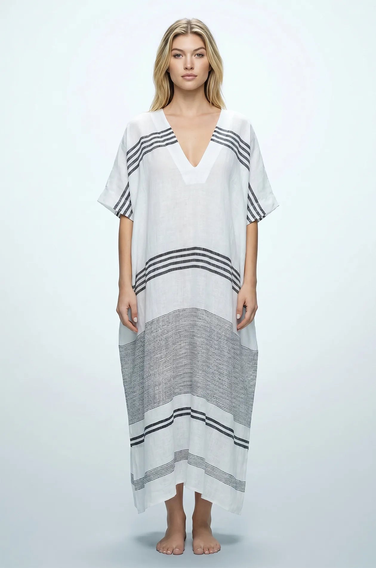 Naylara Dalia white and black striped maxi kaftan — front view with deep V-neck, studio shot